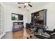 This office features wood floors, massage chair, dark wood furniture, and a TV at 8307 Bluevine Sky Dr, Land O Lakes, FL 34637