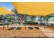 Well-maintained playground with swings covered by a large yellow sunshade canopy at 8307 Bluevine Sky Dr, Land O Lakes, FL 34637