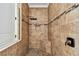 Updated shower with stone tile and matte black fixtures at 8307 Bluevine Sky Dr, Land O Lakes, FL 34637