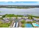Aerial view showcasing lakeside condos, with a dock, tennis court, swimming pool and convenient parking at 9209 Seminole Blvd # 145, Seminole, FL 33772