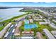 Overhead shot of a lakeside community offering a pool, tennis courts, and convenient parking at 9209 Seminole Blvd # 145, Seminole, FL 33772