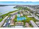 Overhead shot of a lakeside community offering a pool, tennis courts, and convenient parking at 9209 Seminole Blvd # 145, Seminole, FL 33772