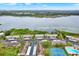 Aerial view showcasing lakeside condos, with a dock, tennis court, swimming pool and convenient parking at 9209 Seminole Blvd # 145, Seminole, FL 33772