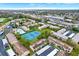 Aerial view of a community with pool, tennis courts, parking, and nearby shopping at 9209 Seminole Blvd # 145, Seminole, FL 33772