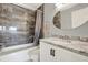This bathroom has a tiled shower and a modern vanity with a granite countertop at 9209 Seminole Blvd # 145, Seminole, FL 33772