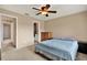 This bedroom with carpet features a ceiling fan and access to the bathroom at 9209 Seminole Blvd # 145, Seminole, FL 33772