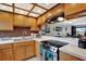 Well-lit kitchen with oak cabinets, updated appliances, and a stylish backsplash, perfect for cooking and entertaining at 9209 Seminole Blvd # 145, Seminole, FL 33772