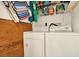Functional laundry area features a side by side washer and dryer setup with shelves for storage at 9209 Seminole Blvd # 145, Seminole, FL 33772