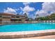 Inviting community pool featuring lounge chairs and shaded seating for relaxation on a beautiful day at 9209 Seminole Blvd # 145, Seminole, FL 33772