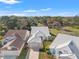 Beautiful home and landscaping with a white tile roof and brick driveway on a sunny day in a scenic neighborhood at 9339 Creole Ct, Weeki Wachee, FL 34613