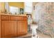 Yellow bathroom featuring a wood vanity, a framed mirror, and a floral-patterned shower curtain at 9339 Creole Ct, Weeki Wachee, FL 34613