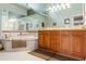 Bright bathroom featuring a double vanity, soaking tub, and tile flooring at 9339 Creole Ct, Weeki Wachee, FL 34613