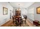 Elegant dining room featuring a chandelier, and a round table set for six, perfect for gatherings at 9339 Creole Ct, Weeki Wachee, FL 34613