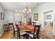 Traditional dining room featuring wood table, chandelier, and decorative rug at 9339 Creole Ct, Weeki Wachee, FL 34613