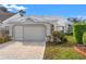 Charming home featuring a well-manicured lawn and a lovely brick driveway and walkway to the front door at 9339 Creole Ct, Weeki Wachee, FL 34613