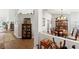 Bright and inviting hallway with hardwood floors, leading to various rooms with stylish decor and neutral color palette at 9339 Creole Ct, Weeki Wachee, FL 34613