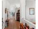 Bright and inviting hallway with hardwood floors, leading to various rooms with stylish decor and neutral color palette at 9339 Creole Ct, Weeki Wachee, FL 34613