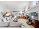 Inviting living room with high ceilings, wood floors, and a large sectional sofa at 9339 Creole Ct, Weeki Wachee, FL 34613