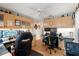 A functional home office featuring built-in cabinets, multiple monitors and two office chairs at 9339 Creole Ct, Weeki Wachee, FL 34613