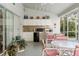 Enclosed outdoor kitchen with sink, mini fridge, and counter seating area, connected to patio and pool at 9339 Creole Ct, Weeki Wachee, FL 34613