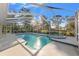 Enclosed pool and hot tub area with sunny sky and mature landscaping views at 9339 Creole Ct, Weeki Wachee, FL 34613