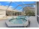 Hot tub and pool are enclosed by a screened-in lanai connected to the home's patio at 9339 Creole Ct, Weeki Wachee, FL 34613