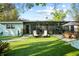 Well-maintained backyard with synthetic grass, patio area, and lush landscaping at 9466 127Th Ave, Largo, FL 33773