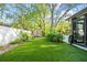 Lush backyard with synthetic grass, storage shed, and privacy landscaping at 9466 127Th Ave, Largo, FL 33773