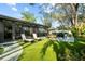 Serene backyard with synthetic grass, patio area, and comfortable lounge furniture at 9466 127Th Ave, Largo, FL 33773