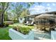 Inviting backyard with artificial turf, patio, lounge chairs, an outdoor table, and a hot tub at 9466 127Th Ave, Largo, FL 33773