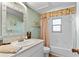 Charming bathroom with a stylish vanity, decorative mirror, and a shower-tub combination at 9466 127Th Ave, Largo, FL 33773