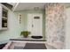 Front door with a decorative stone accent wall, house number and potted plant at 9466 127Th Ave, Largo, FL 33773