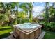 Relaxing hot tub surrounded by lush tropical foliage in a private backyard setting at 9466 127Th Ave, Largo, FL 33773