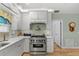 This kitchen showcases modern appliances with white cabinetry and quartz countertops at 9466 127Th Ave, Largo, FL 33773