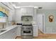 Bright kitchen with stainless steel appliances and white cabinetry at 9466 127Th Ave, Largo, FL 33773