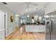 Open concept living and kitchen featuring a large island, fireplace and hardwood floors at 9466 127Th Ave, Largo, FL 33773