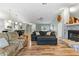 Inviting living room featuring hardwood floors, a stone fireplace, and stylish furnishings at 9466 127Th Ave, Largo, FL 33773