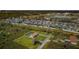 Aerial view showcasing a neighborhood, with focus on a home featuring a screened pool at 10603 1St St, Riverview, FL 33569