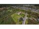 Aerial view of home showcasing screened pool and large lot surrounded by green space at 10603 1St St, Riverview, FL 33569