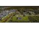 Aerial view of home showcasing screened pool and large lot surrounded by green space at 10603 1St St, Riverview, FL 33569