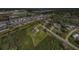 Aerial view of home showcasing screened pool and large lot surrounded by green space at 10603 1St St, Riverview, FL 33569