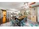 Open dining area features a modern table with seating for four, adjacent to the kitchen with stainless steel appliances at 10603 1St St, Riverview, FL 33569