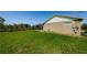 Exterior view showing a screened-in pool and large grassy area at 10603 1St St, Riverview, FL 33569