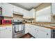 Kitchen features stainless steel appliances, white cabinets, and efficient layout for cooking at 10603 1St St, Riverview, FL 33569