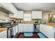 Kitchen featuring white cabinets, stainless steel appliances, and a view of the sink with natural light at 10603 1St St, Riverview, FL 33569