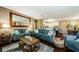 Open living area with cozy sofas, dark wood floors, and seamless access to the kitchen at 10603 1St St, Riverview, FL 33569