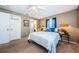 Bedroom with carpeted floors, ceiling fan, ensuite bathroom, and bright natural light at 10603 1St St, Riverview, FL 33569