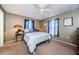 Bedroom with neutral tones, ceiling fan, carpeted floors, and bright natural light at 10603 1St St, Riverview, FL 33569