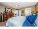 Bedroom with carpeted floors, a spacious layout, and a view into the ensuite bathroom at 10603 1St St, Riverview, FL 33569