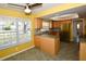 Bright eat-in kitchen featuring light wood cabinetry, tile floors, and stainless steel appliances at 1108 Live Oak Ct, Clearwater, FL 33756